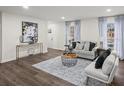 Inviting living room features hardwood floors, neutral walls, and plentiful natural light through large windows at 3308 Wildwood Sw Dr, Marietta, GA 30060