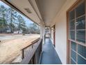 Inviting covered porch with views of the neighborhood and classic railings at 3308 Wildwood Sw Dr, Marietta, GA 30060