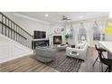 Spacious living room with fireplace, hardwood floors, and large windows at 6233 Thorncrest Dr, Tucker, GA 30084