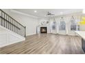 Open living area with hardwood floors, fireplace, and access to staircase at 6233 Thorncrest Dr, Tucker, GA 30084