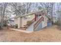 Brick Ranch home with a red front door and wooden stairs at 2906 Monterey Dr, Decatur, GA 30032