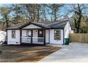 Newly renovated home with a modern exterior and driveway at 1816 Ledo Ave, Decatur, GA 30035