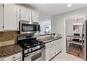 Modern kitchen with stainless steel appliances and granite countertops at 4676 Vinings Central Se Run # 104, Atlanta, GA 30339