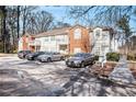Two-story townhome building with parking and landscaping at 4008 Orchard Hill Ter, Stone Mountain, GA 30083