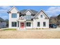 Elegant two-story home boasts a classic design with a red front door and professionally landscaped front yard at 1010 Nours Cir, Lawrenceville, GA 30045