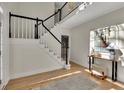 Two-story foyer with hardwood floors and elegant staircase at 3405 Doral Ln, Woodstock, GA 30189