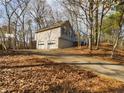 Two-car garage with driveway and basketball court at 1508 Towne Harbor Ln, Woodstock, GA 30189