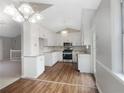 Eat-in kitchen with white cabinets and modern appliances at 1508 Towne Harbor Ln, Woodstock, GA 30189