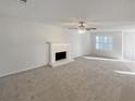 Spacious living room featuring a fireplace and neutral carpeting at 169 Hunters, Mcdonough, GA 30253