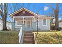 Cute bungalow with front porch and steps leading to the entrance at 135 Adair Se Ave, Atlanta, GA 30315