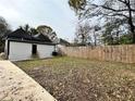 Large backyard enclosed by a tall wooden fence, offering plenty of space for activities at 701 Cameron M Alexander Nw Blvd, Atlanta, GA 30318