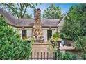 Outdoor patio with stone fireplace and seating area at 250 Lakeview Ne Ave, Atlanta, GA 30305