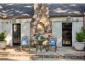 Back patio with stone fireplace, ornate seating, and decorative potted plants at 250 Lakeview Ne Ave, Atlanta, GA 30305