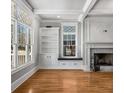 Bright living room with hardwood floors, fireplace, built-in shelving, and large windows at 1271 Fenway Cir, Decatur, GA 30030