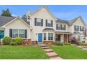 Two-story townhome with brick and siding exterior, landscaped lawn, and parking at 145 Gentle Breeze Ct, Temple, GA 30179