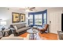 Living room features hardwood floors, bay window, and comfortable seating at 145 Gentle Breeze Ct, Temple, GA 30179