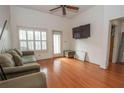 Spacious living room featuring hardwood floors and a large TV at 1250 Parkwood Cir # 2312, Atlanta, GA 30339