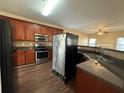 Spacious kitchen featuring granite countertops, stainless steel appliances and wood flooring at 308 Jarrod Oaks Ct, Loganville, GA 30052