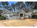 A charming house with gray siding and a well-maintained lawn surrounded by lush green trees at 889 City Park Se Dr, Atlanta, GA 30312