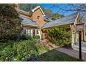 Inviting brick home exterior with lush landscaping and a brick pathway at 11 Ivy Chase Ne, Atlanta, GA 30342