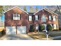 Two-story brick home, two-car garage, curb appeal at 4038 Ash Tree St, Snellville, GA 30039