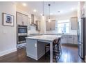 Modern kitchen with gray cabinets, quartz countertops, and stainless steel appliances at 927 Katie Kerr Dr, Decatur, GA 30030