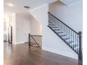 View of a modern dark stained wood staircase with metal railing from the living room at 927 Katie Kerr Dr, Decatur, GA 30030