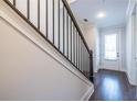 Modern dark-stained wood staircase with black metal railing at 927 Katie Kerr Dr, Decatur, GA 30030