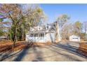 Charming house exterior with gray siding and detached garage at 3245 Sharon Dr, Powder Springs, GA 30127