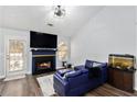 Living room with fireplace, hardwood floors, and sectional sofa at 4749 Brookwood Vw, Atlanta, GA 30349