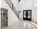 Bright entryway with statement tile floor, staircase, and wine storage at 500 Ridgewater Dr, Marietta, GA 30068