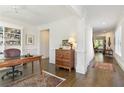 Office leading to hallway featuring hardwood floors, white trim, and custom built-ins at 11644 Parkside Ave, Alpharetta, GA 30005