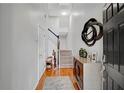 Inviting entryway with hardwood floors, stairs, decorative mirror and furniture at 2116 Tidal Cv, Lawrenceville, GA 30043