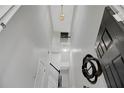 Entryway view showing the staircase and decorative mirror at 2116 Tidal Cv, Lawrenceville, GA 30043
