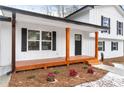 Inviting front porch with wooden posts and a spacious deck at 85 Hickory Dr, Stockbridge, GA 30281