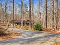Secluded home with a long driveway surrounded by mature trees offering privacy at 5295 Ridge Rd, Douglasville, GA 30134