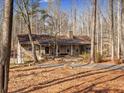Beautiful stone home nestled among the trees with a large front porch and welcoming entrance at 5295 Ridge Rd, Douglasville, GA 30134