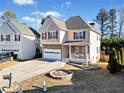 Two-story house with stone accents and a landscaped yard at 902 College Place Nw Ct, Kennesaw, GA 30144