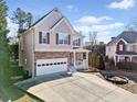 Two-story house with stone accents and a spacious driveway at 902 College Place Nw Ct, Kennesaw, GA 30144