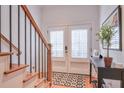 Bright entryway with stairs, French doors, and a console table at 235 Founders Mill Ct, Roswell, GA 30075