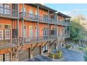 Multi-level brick home with balconies, garage parking and partial landscape view at 235 Founders Mill Ct, Roswell, GA 30075