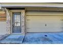 Welcoming doorway, a convenient two-car garage, and brick details at 247 Bell Grove Ln, Suwanee, GA 30024