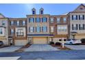 Lovely brick townhome with a two-car garage and dormer windows at 247 Bell Grove Ln, Suwanee, GA 30024