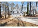 Gray house with a three-car garage and driveway, surrounded by trees at 118 Michael Ct, Dallas, GA 30157