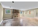 Finished basement with a stone fireplace and concrete floors at 2038 Clairmont Ne Ter, Atlanta, GA 30345