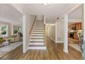 Inviting entryway with hardwood floors, staircase, and views into the living room and kitchen at 2189 Wood Glen Se Ln, Marietta, GA 30067