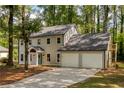 Charming two-story home featuring a well-manicured lawn, and a two car garage at 2189 Wood Glen Se Ln, Marietta, GA 30067