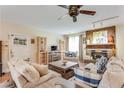 Comfortable living room with a ceiling fan and brick fireplace, perfect for relaxing or entertaining guests at 3119 E Fairview Rd, Mcdonough, GA 30252