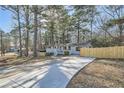 House with long driveway, wood fence, and shed in backyard at 127 Robinhood Dr, Woodstock, GA 30188