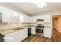 Clean kitchen with white cabinets, stainless steel appliances, and granite countertops at 6110 Dorsett St, Douglasville, GA 30134